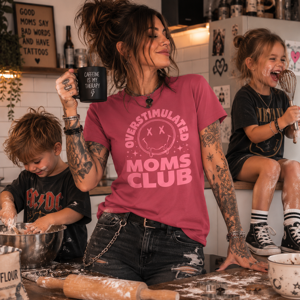 overstimulated moms club shirt, mom life t-shirt, overwhelmed mom shirt, funny mom graphic tee, motherhood chaos shirt, busy mom outfit, alternative mom style, rock mom t-shirt, mom of girls shirt, toddler mom apparel, everyday mom life tee, parenting humor shirt, women’s graphic t-shirt, pink mom shirt, relatable mom gift, kitchen chaos mom shirt, stay at home mom tee, modern motherhood shirt, edgy mom fashion, Merloan mom shirt